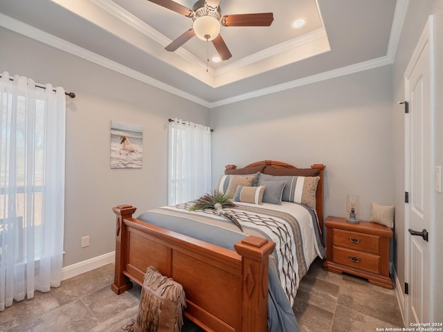 bedroom featuring a tray ceiling, ceiling fan, and ornamental molding