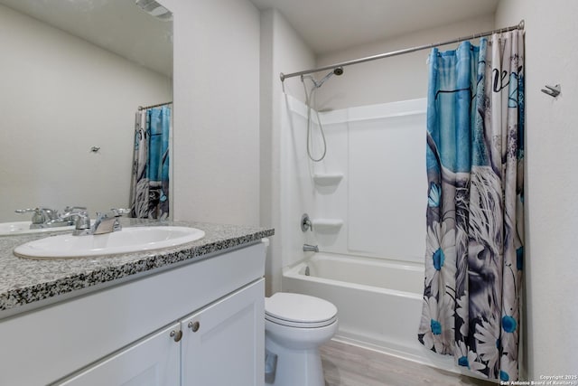 full bathroom featuring toilet, vanity, hardwood / wood-style flooring, and shower / bathtub combination with curtain