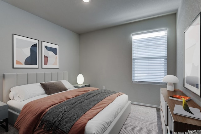 bedroom featuring light colored carpet