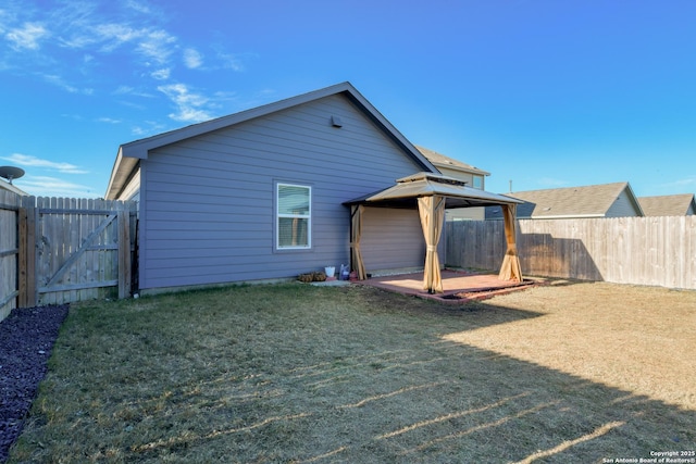 rear view of property featuring a patio area and a lawn