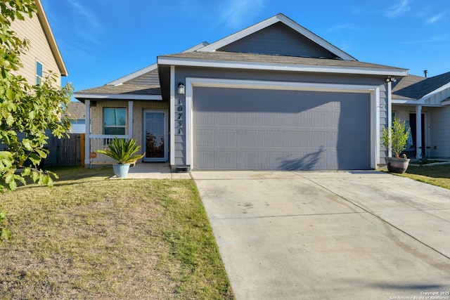 single story home featuring a garage and a front lawn