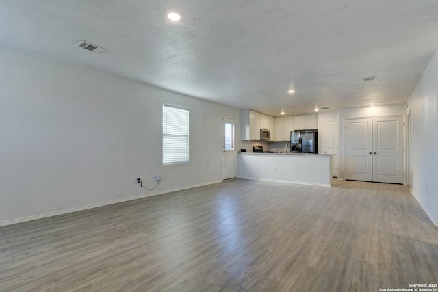 unfurnished living room with light wood-type flooring