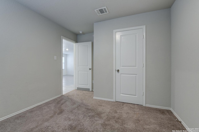 unfurnished bedroom with light colored carpet