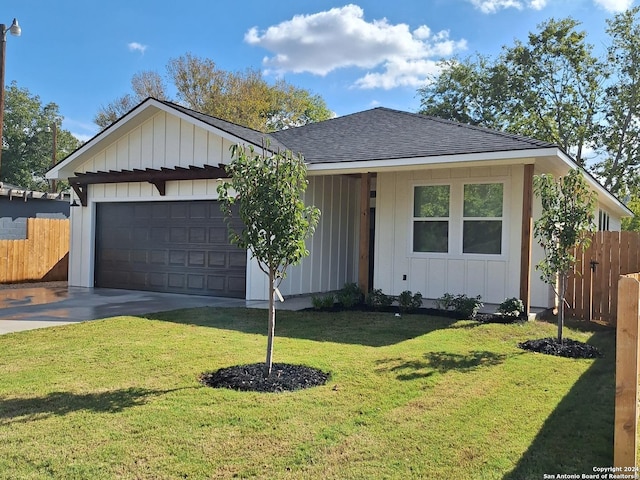 ranch-style house with a garage and a front yard