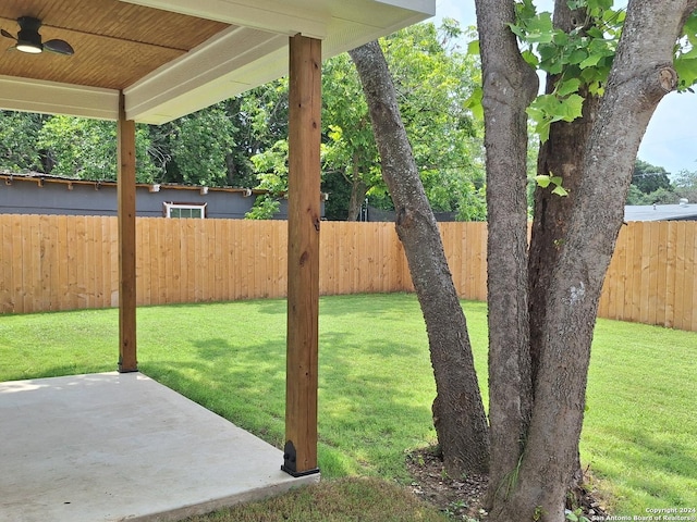 view of yard featuring ceiling fan and a patio