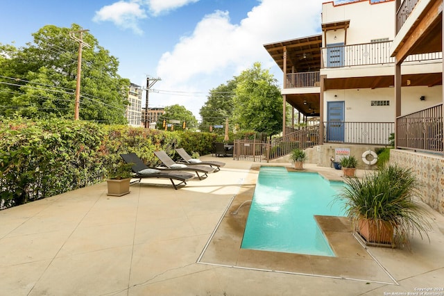 view of swimming pool with a patio area