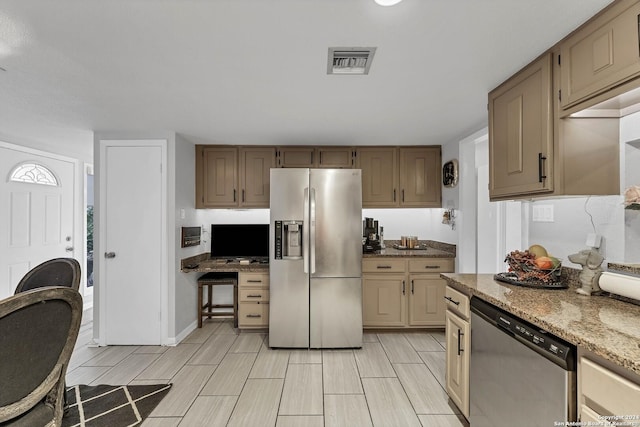 kitchen featuring light stone countertops and appliances with stainless steel finishes