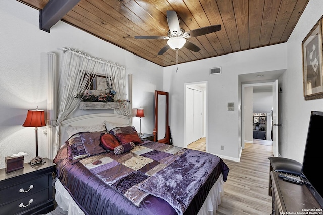 bedroom with beamed ceiling, light hardwood / wood-style flooring, ceiling fan, and wood ceiling