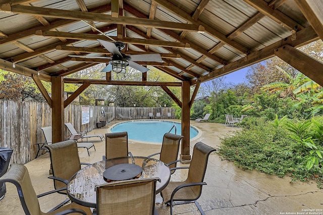 view of patio featuring a gazebo, ceiling fan, and a fenced in pool