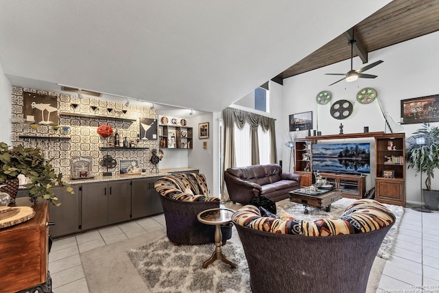 tiled living room featuring vaulted ceiling with beams and ceiling fan