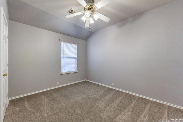 carpeted spare room featuring ceiling fan and lofted ceiling