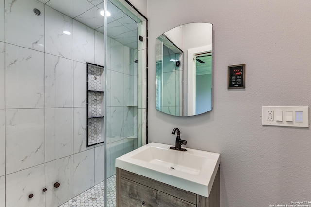 bathroom with vanity and tiled shower