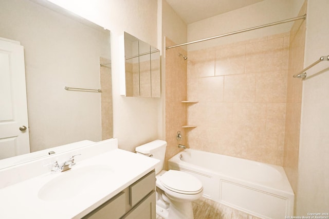 full bathroom with vanity, tiled shower / bath combo, and toilet