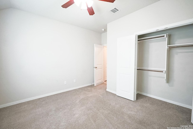 unfurnished bedroom with light carpet, a closet, ceiling fan, and lofted ceiling