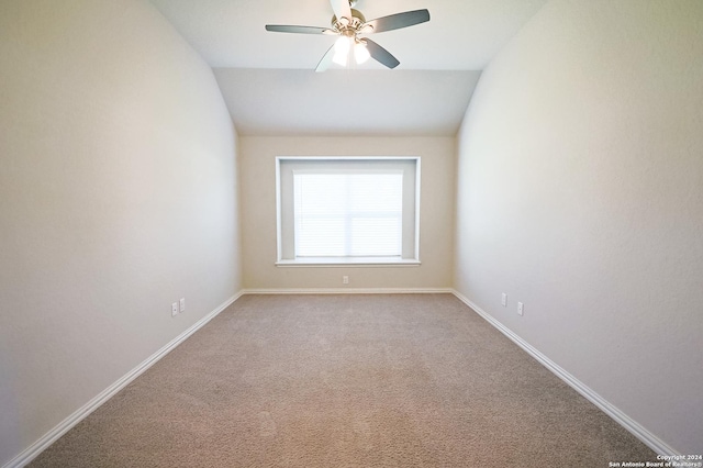 carpeted empty room with vaulted ceiling and ceiling fan