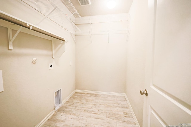 laundry area with light wood-type flooring and electric dryer hookup