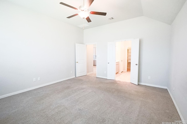 unfurnished bedroom with carpet flooring, ensuite bathroom, high vaulted ceiling, and ceiling fan