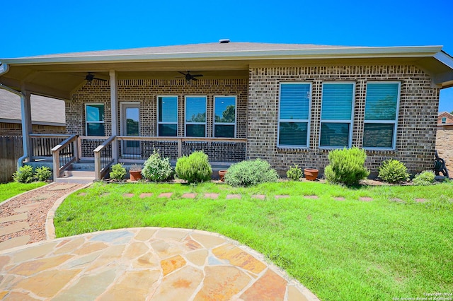 exterior space with a front lawn and ceiling fan