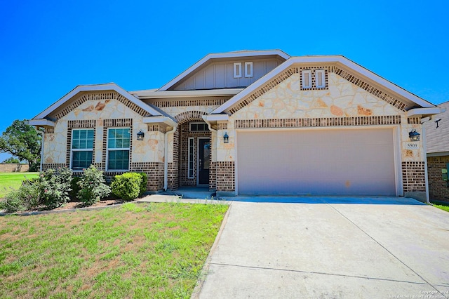 view of front of home with a front lawn and a garage