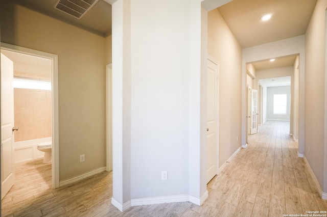 corridor with light wood-type flooring