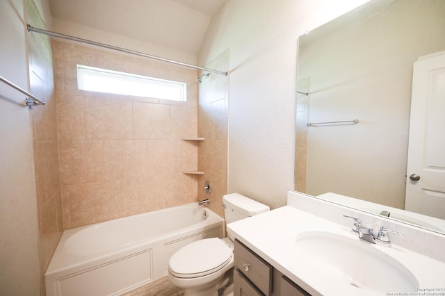 full bathroom featuring vanity, toilet, tiled shower / bath, and lofted ceiling