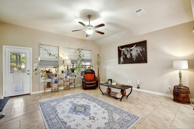 sitting room with ceiling fan, tile patterned flooring, and vaulted ceiling