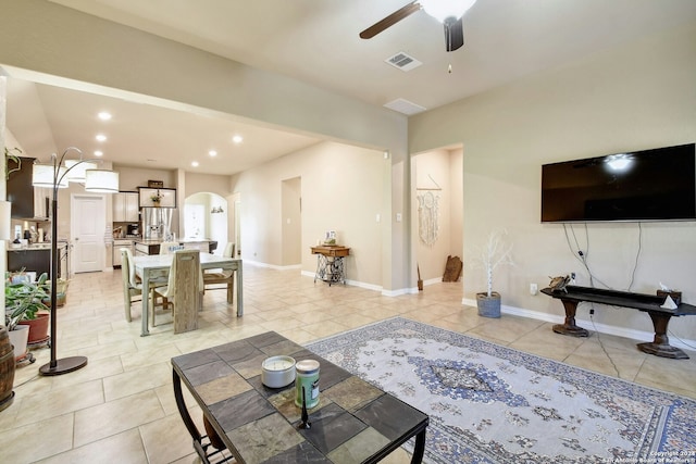 tiled living room with ceiling fan