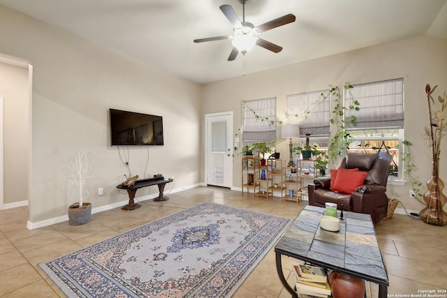 tiled living room with ceiling fan