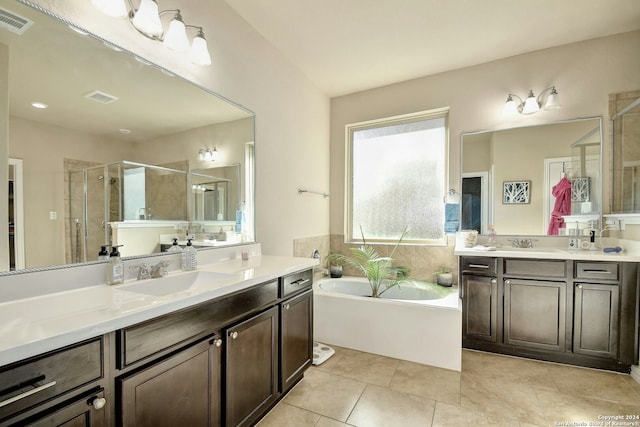 bathroom with tile patterned floors, vanity, and plus walk in shower