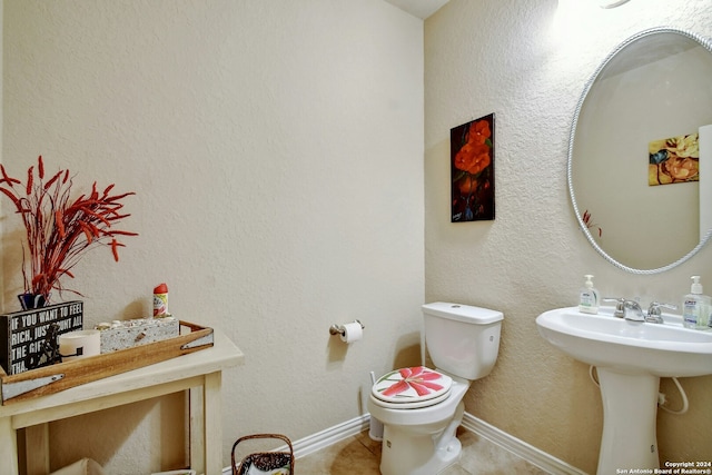 bathroom with tile patterned floors, toilet, and sink