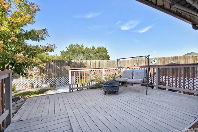 wooden terrace featuring a fire pit