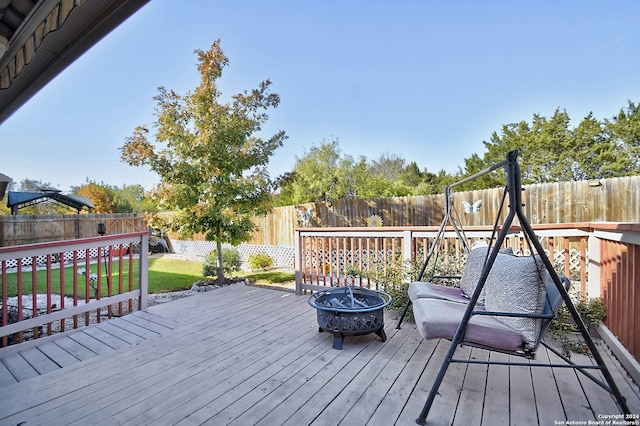 wooden deck with an outdoor fire pit