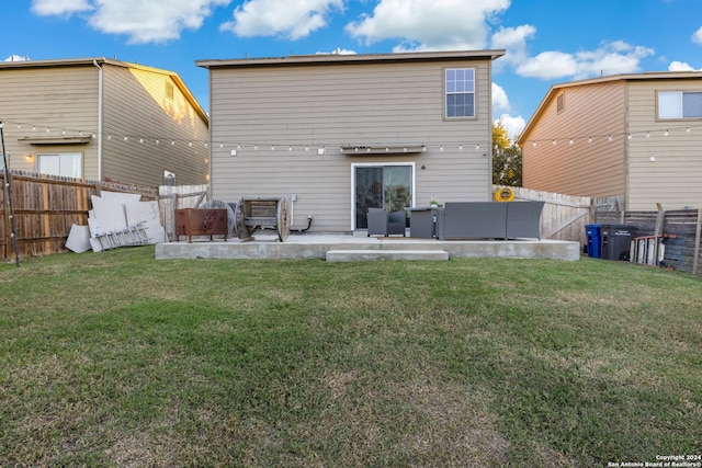 back of property featuring a lawn and a patio