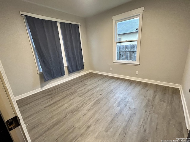 unfurnished room with hardwood / wood-style floors