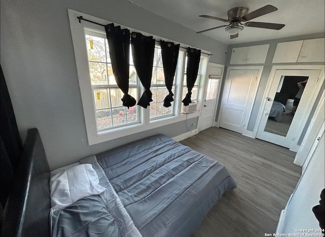 bedroom with wood-type flooring and ceiling fan