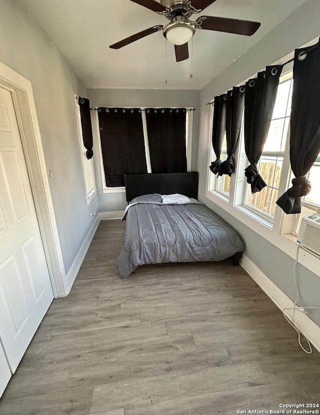 unfurnished bedroom with ceiling fan and light hardwood / wood-style floors