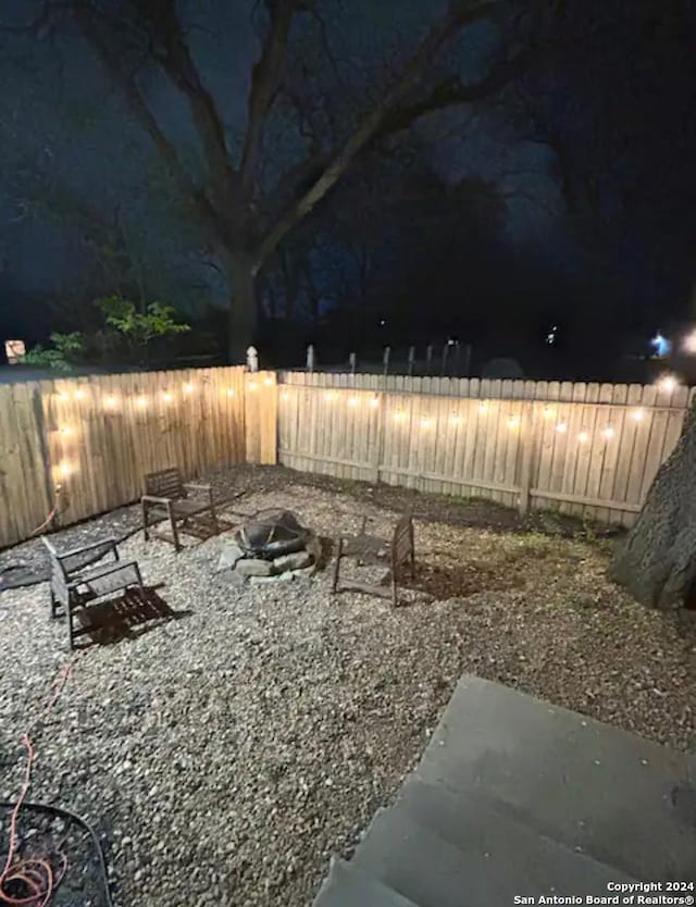 yard at twilight featuring a fire pit