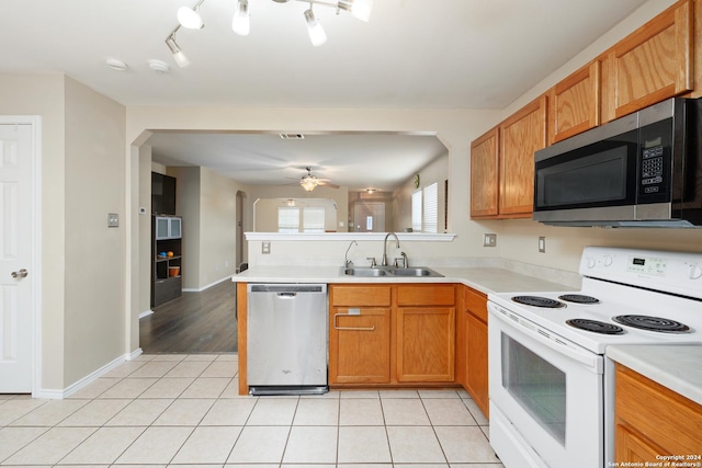 kitchen featuring ceiling fan, light tile patterned floors, sink, and appliances with stainless steel finishes