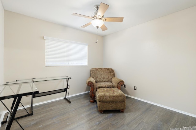 living area with wood-type flooring and ceiling fan