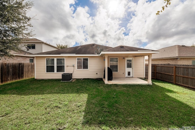 back of property featuring a patio area and a lawn