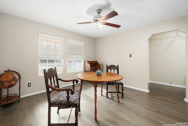 dining area with ceiling fan and dark hardwood / wood-style floors