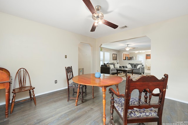 dining space with ceiling fan and dark hardwood / wood-style floors