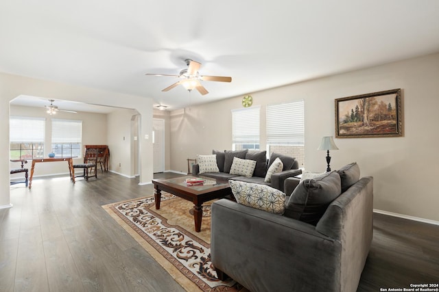 living room featuring dark hardwood / wood-style floors and ceiling fan