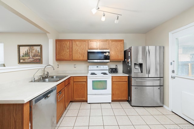 kitchen with sink, light tile patterned floors, and appliances with stainless steel finishes