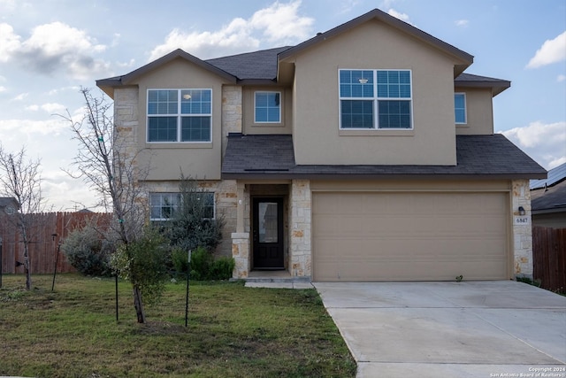 view of front of house featuring a front yard and a garage