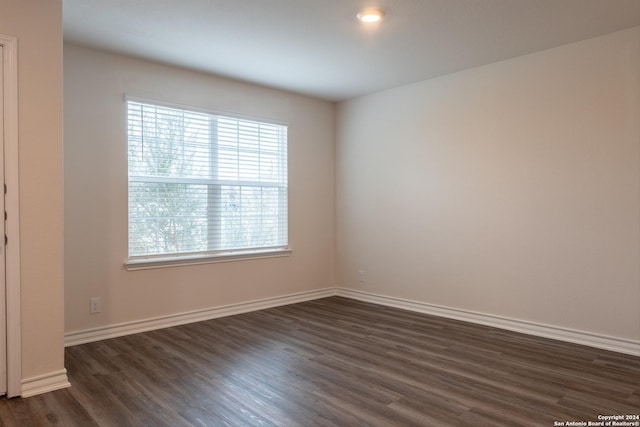 unfurnished room featuring dark hardwood / wood-style floors