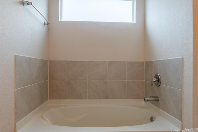 bathroom featuring a washtub and plenty of natural light