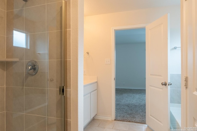 bathroom with tile patterned flooring, vanity, and a shower with shower door