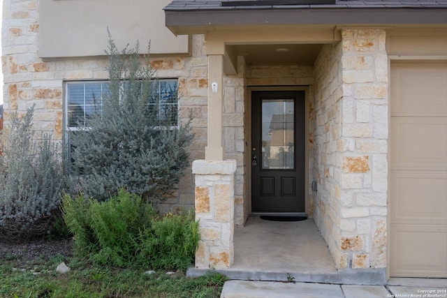 view of exterior entry with a garage