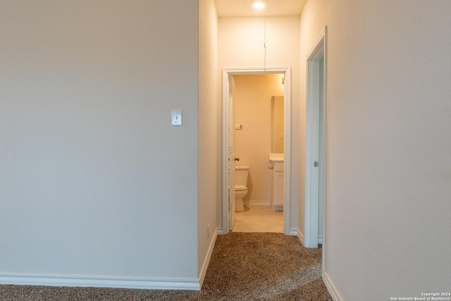 hallway with light colored carpet